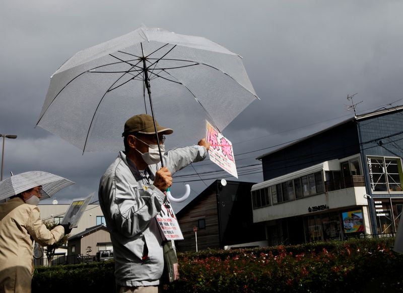 &copy; Reuters. FILE PHOTO: An anti-nuclear activist demonstrates in front of the Tokyo Electric Power Company Holdings office in Niigata, Niigata Prefecture, Japan, October 21, 2021. REUTERS/Sakura Murakami