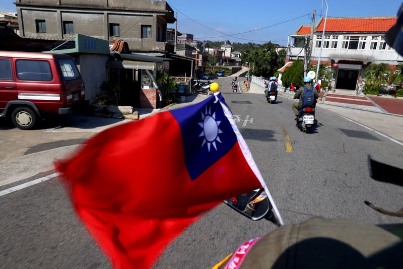 &copy; Reuters. The flag of Taiwan flies on a scooter driving through a village on Kinmen, Taiwan, October 18, 2021. Sitting on the front line between Taiwan and China, Kinmen is the last place where the two engaged in major fighting, in 1958 at the height of the Cold Wa