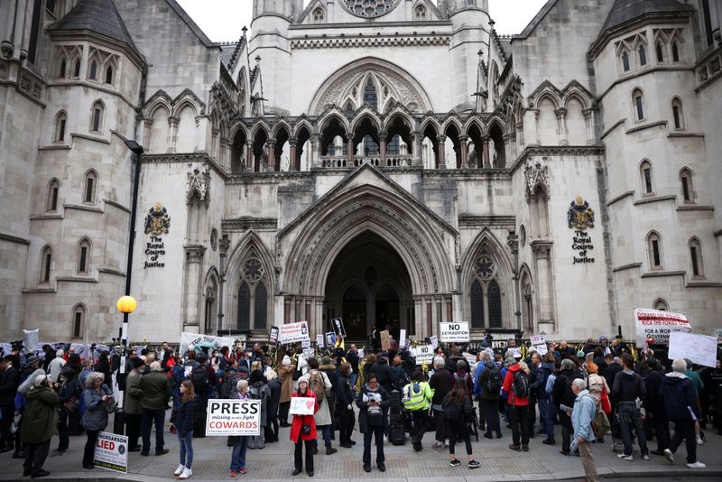 &copy; Reuters. Supporters of Wikileaks founder Julian Assange protest outside the Royal Courts of Justice in London, Britain, October 27, 2021. REUTERS/Henry Nicholls