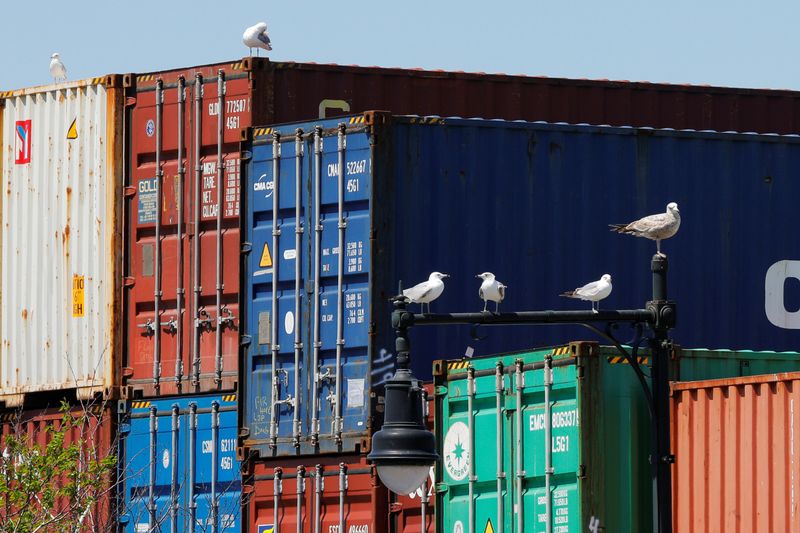 &copy; Reuters. FILE PHOTO: Sea gulls sit on a lamppost beside shipping containers stacked at the Paul W. Conley Container Terminal in Boston, Massachusetts, U.S., May 9, 2018.   REUTERS/Brian Snyder