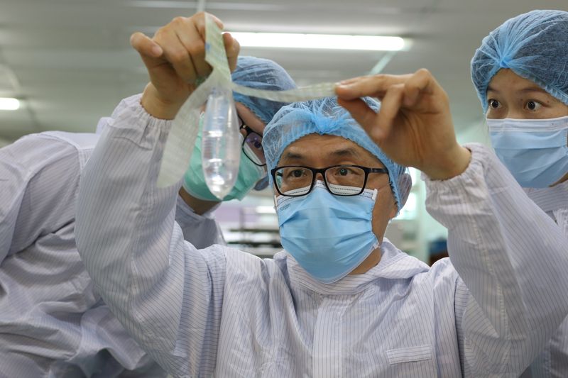&copy; Reuters. Founder and inventor of Wondaleaf Unisex Condom John Tang Ing Ching inspects the unisex condom at his factory in Sibu, Malaysia October 19, 2021. Picture taken October 19, 2021. Twin Catalyst/Handout via REUTERS 