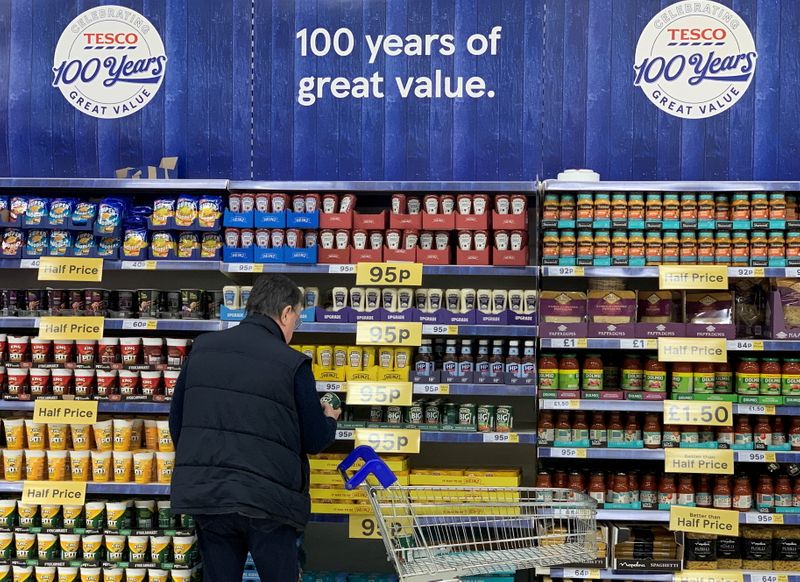 &copy; Reuters. FILE PHOTO: A man looks at products on a shelf inside a Tesco Extra superstore near Manchester, Britain, January 8, 2020. REUTERS/Phil Noble/File Photo