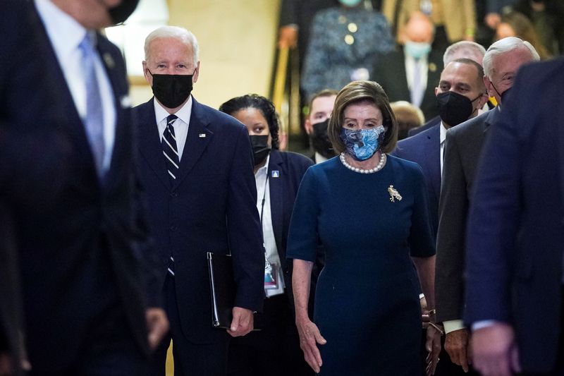 © Reuters. U.S. President Joe Biden is escorted by House Speaker Nancy Pelosi (D-CA) as he arrives to speak with the House Democratic Caucus to provide an update on the Build Back Better agenda and the bipartisan infrastructure deal at the U.S. Capitol, October 28, 2021. REUTERS/Al Drago  