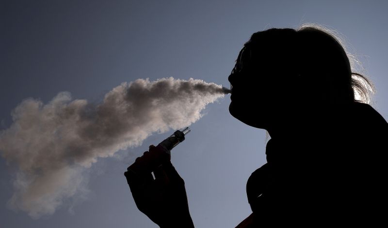 &copy; Reuters. FILE PHOTO: A woman exhales vapour from an e-cigarette outside the offices of British e-cigarette manufacturer Totally Wicked in Blackburn, northern England March 19, 2015. REUTERS/Phil Noble     