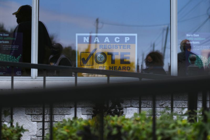 &copy; Reuters. FILE PHOTO: People attend an event hosted by the NAACP to encourage community members to vote in the upcoming presidential election in Houston, Texas, U.S., October 24, 2020. REUTERS/Callaghan O'Hare