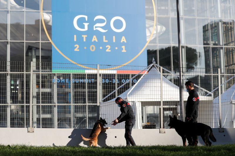 &copy; Reuters. FILE PHOTO: Carabinieri police officers inspect the area with explosive detection dogs outside the convention centre "La Nuvola" (the cloud) ahead of the G20 summit in Rome, Italy, October 27, 2021. REUTERS/Yara Nardi