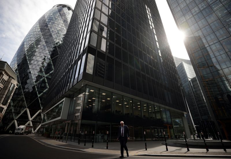 &copy; Reuters. FILE PHOTO: A person walks through the City of London financial district in London, Britain, September 13, 2021. REUTERS/Hannah McKay