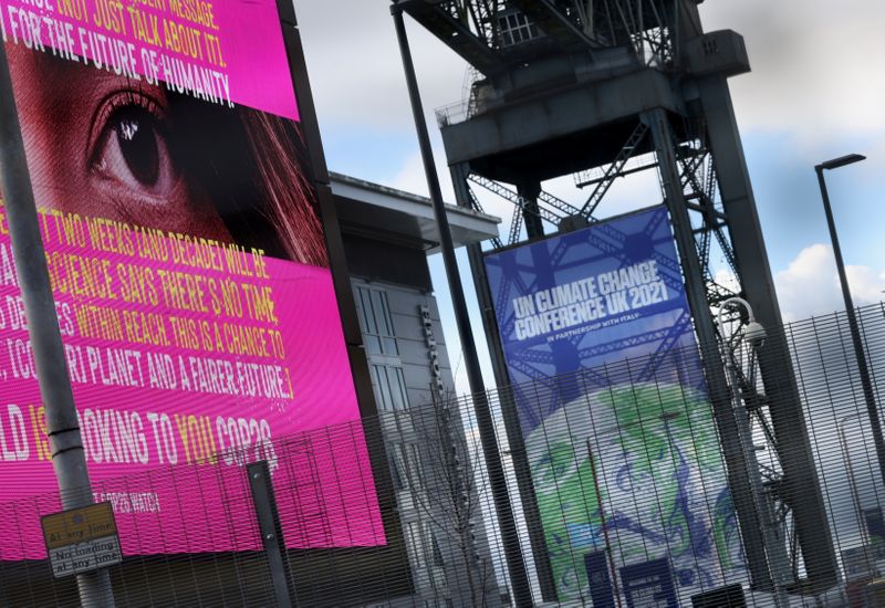 © Reuters. A banner advertising the UN Climate Change Conference (COP 26) where world leaders discuss how to tackle climate change on a global scale, is seen inside the conference area in Glasgow Scotland, Britain October 30, 2021.  REUTERS/Yves Herman