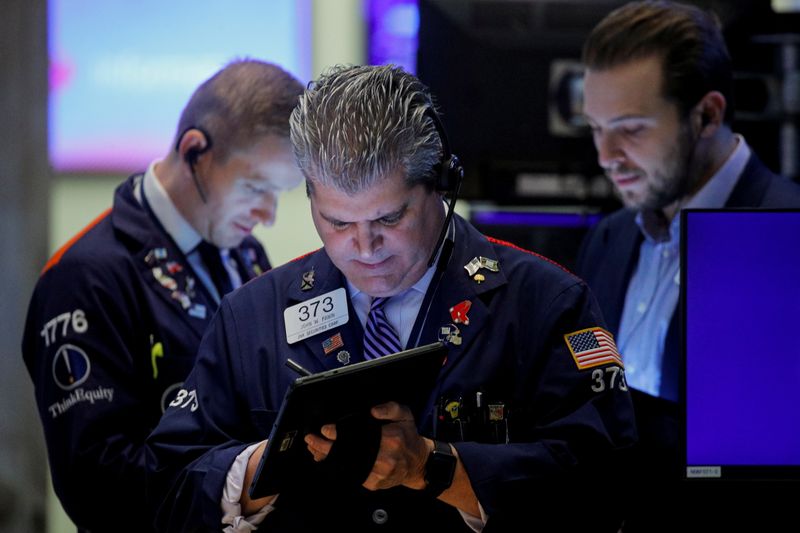 &copy; Reuters. FILE PHOTO: Traders work on the floor of the New York Stock Exchange (NYSE) in New York City, U.S., October 27, 2021.  REUTERS/Brendan McDermid