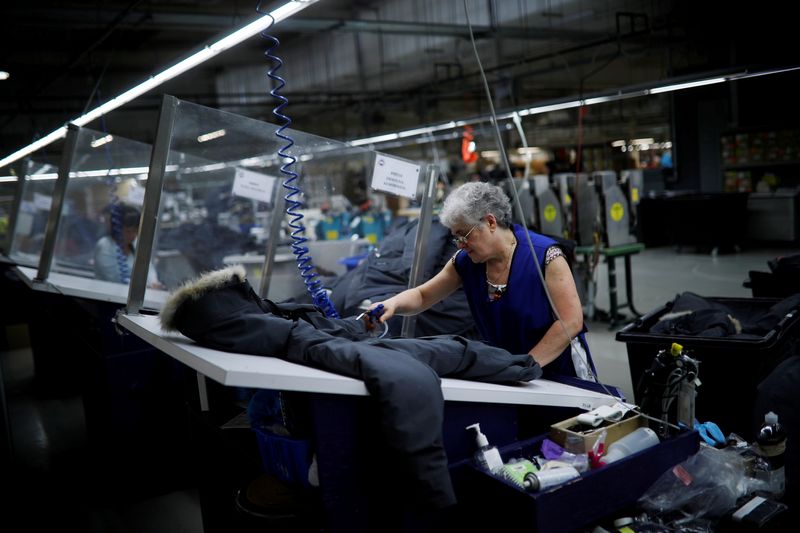 © Reuters. FILE PHOTO: Workers make jackets at the Canada Goose factory in Toronto, Ontario, Canada, February 23, 2018.   REUTERS/Mark Blinch/File Photo