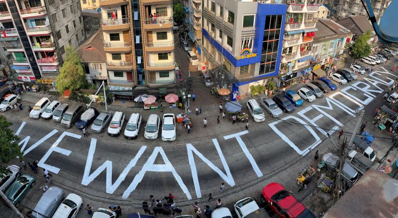&copy; Reuters. FILE PHOTO: A slogan is written on a street as a protest after the coup in Yangon, Myanmar February 21, 2021. Picture taken with iPhone panoramic mode. REUTERS/Stringer/File Photo