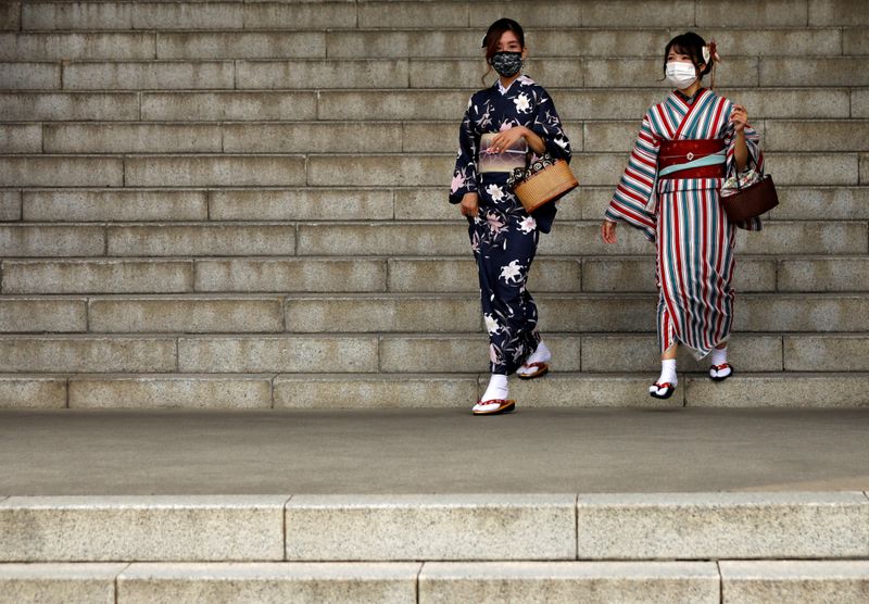 &copy; Reuters. Kimono-clad tourists wearing protective face masks are seen at a temple at Asakusa district, a popular sightseeing spot, amid the coronavirus disease (COVID-19) outbreak in Tokyo, Japan October 13, 2020.   REUTERS/Issei Kato/Files