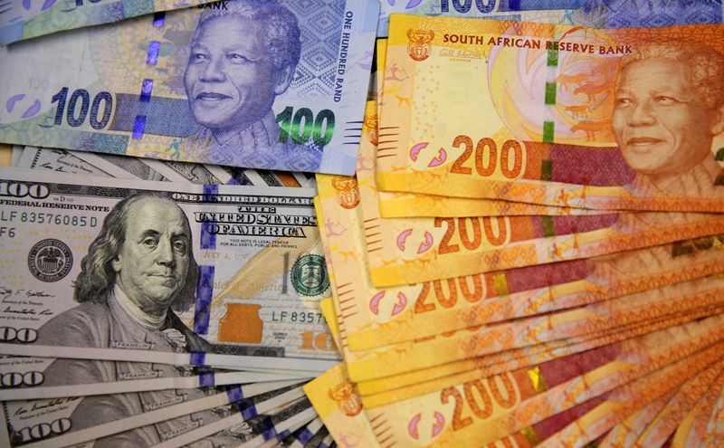 &copy; Reuters. FILE PHOTO: South African bank notes featuring images of former South African President Nelson Mandela (R) are displayed next to the American dollar notes in this photo illustration.  REUTERS/Siphiwe Sibeko/File Photo