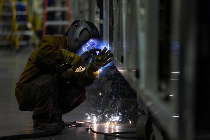 &copy; Reuters. FILE PHOTO: A welder works while building a bus frame at the BYD electric bus factory in Lancaster, California, U.S., July 1, 2021. REUTERS/Mike Blake