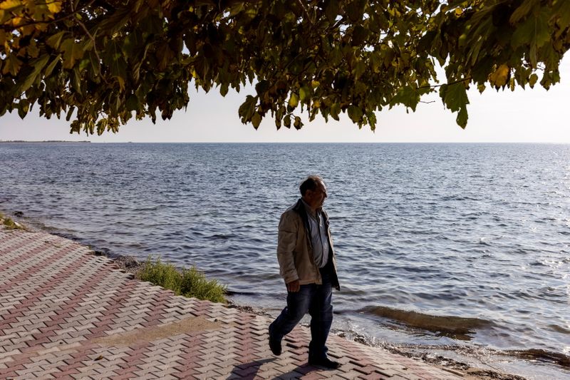 &copy; Reuters. Local George Perperis walks on the damaged pedestrian street of the seaside village of Nea Irakleia, Greece, October 20, 2021. REUTERS/Alkis Konstantinidis