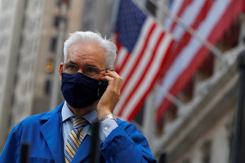 &copy; Reuters. FILE PHOTO: A trader speaks on a phone outside the New York Stock Exchange (NYSE) following Election Day in Manhattan, New York City, U.S., November 4, 2020. REUTERS/Andrew Kelly 