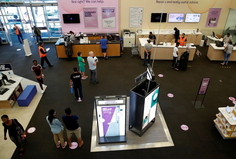 &copy; Reuters. FILE PHOTO: People queue on social distancing markings at the Staples Corner Megastore for Carphone Warehouse and Curry's PC World, as shops re-open following the outbreak of the coronavirus disease (COVID-19), in Brent Cross, London, Britain, June 15, 20