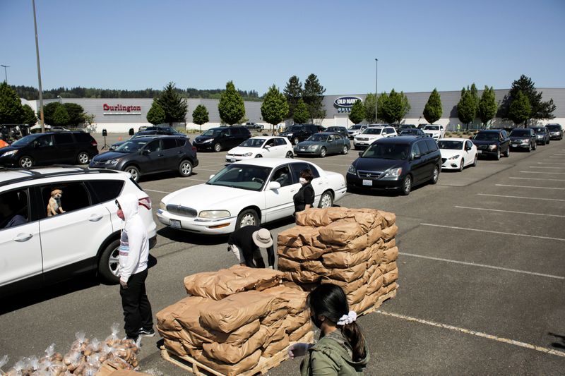 &copy; Reuters. FILE PHOTO: People queue for handouts of excess potatoes, that would otherwise go to waste due to coronavirus-related supply chain blockages, in an event organized by the Washington Potato Commission in Auburn, Washington, U.S. May 7, 2020.  REUTERS/David