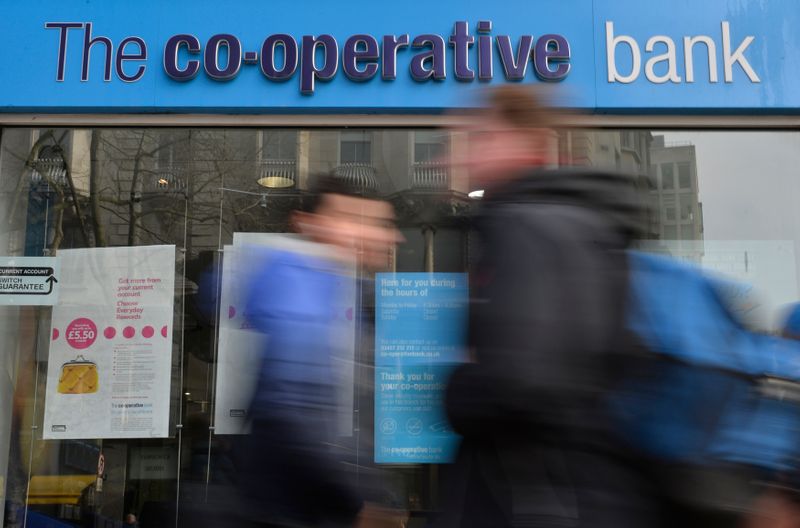 &copy; Reuters. FILE PHOTO: People walk past a branch of The Co-operative Bank in London, Britain, February 13, 2017. REUTERS/Hannah McKay