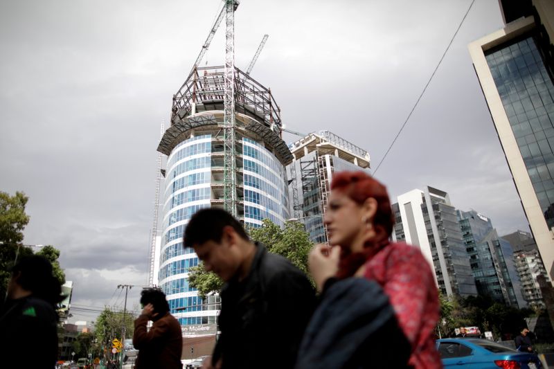 &copy; Reuters. FILE PHOTO: People walk past a building undergoing construction in Mexico City, Mexico January 30, 2020. REUTERS/Andres Martinez Casares/File Photo