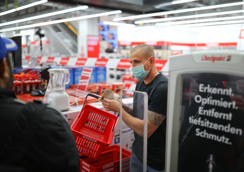 &copy; Reuters. FILE PHOTO: A salesperson serves a customer at the electronics retailer Media Markt, as the spread of the coronavirus disease (COVID-19) continues in Berlin, Germany, April 22, 2020. REUTERS/Hannibal Hanschke