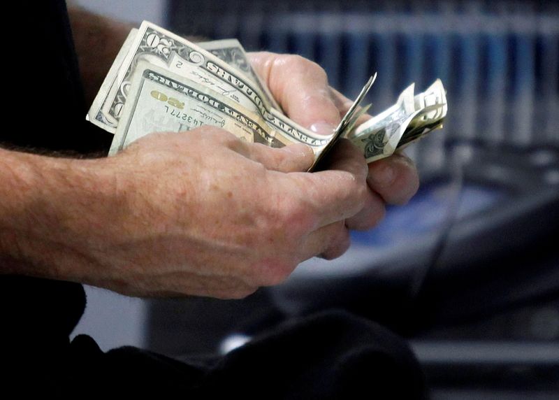 &copy; Reuters. FILE PHOTO: A customer counts his cash at the register while purchasing an item at a Best Buy store in Flushing, New York March 27, 2010.  REUTERS/Jessica Rinaldi