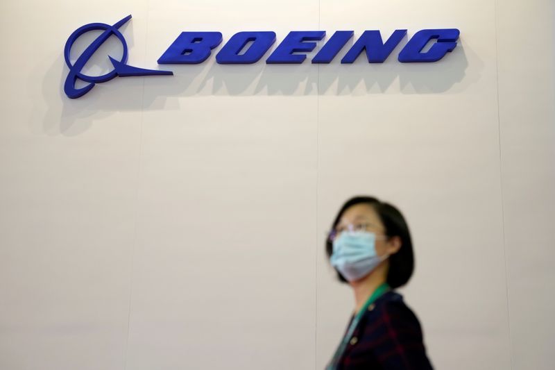 &copy; Reuters. FILE PHOTO: A woman walks past a Boeing logo at the China International Aviation and Aerospace Exhibition, or Airshow China, in Zhuhai, Guangdong province, China September 28, 2021. REUTERS/Aly Song/File Photo
