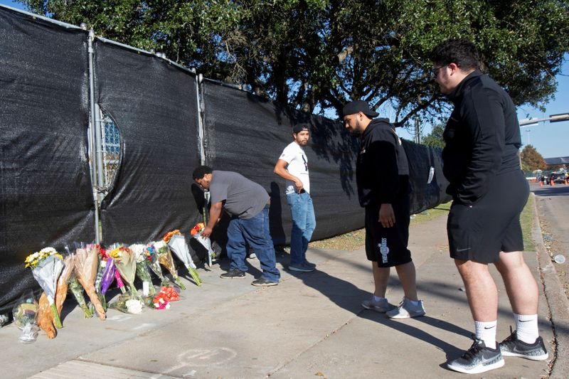 &copy; Reuters. FILE PHOTO: Matthew Shelton, Diego Rivera, Anthony Perez and Juan Carillo place flowers on a gate to NRG Park, after a deadly crush of fans during a performance the night before at the Astroworld Festival by rapper Travis Scott in Houston, Texas, U.S. Nov