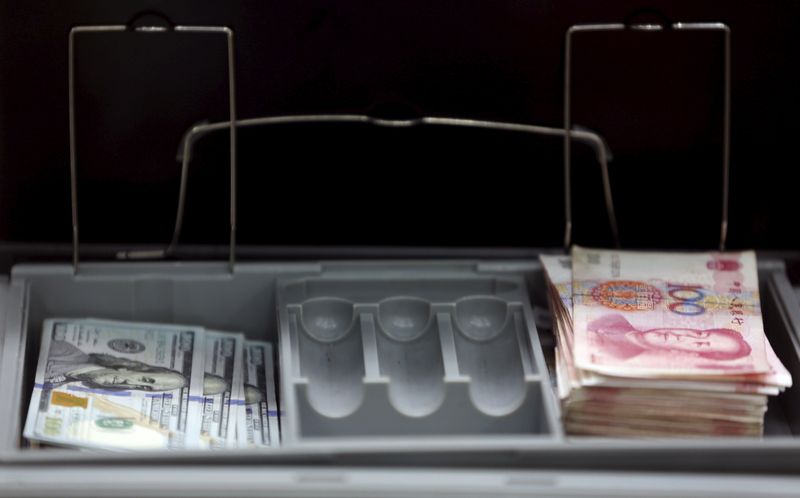 &copy; Reuters. FILE PHOTO: U.S. $100 banknotes and Chinese 100 yuan banknotes are pictured at a branch of a foreign bank in Beijing January 4, 2016.  REUTERS/Kim Kyung-Hoon