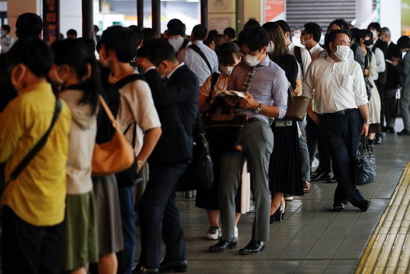 &copy; Reuters. FILE PHOTO: People wait in a line at a taxi stand outside of Shinagawa station, as some train services were suspended due to an earthquake, in Tokyo, Japan, October 8, 2021. REUTERS/Kim Kyung-Hoon