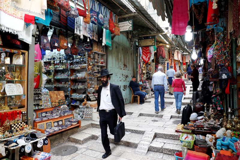 &copy; Reuters. FILE PHOTO: People walk around an alley in Jerusalem's Old City March 9, 2020 REUTERS/ Ronen Zevulun