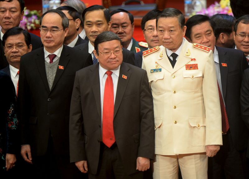 &copy; Reuters. FILE PHOTO: Newly elected Politburo member To Lam, in white uniform, poses  on the podium along with all other new Vietnam Communist Party's central committee members at the closing ceremony of the 8-day-long national congress of the party in Hanoi,  Janu