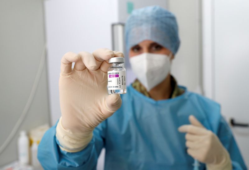 &copy; Reuters. FILE PHOTO: A medical worker holds a vial of a COVID-19 vaccine in a newly opened mass vaccination centre at the Cecchignola military compound, in Rome, Italy, February 23, 2021. REUTERS/Remo Casilli/File Photo
