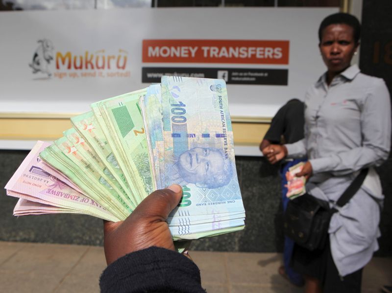 &copy; Reuters. FILE PHOTO: An  forex dealer offers bond notes and South African Rand outside a bank in the central business district in Harare, Zimbabwe, February 24, 2017. REUTERS/Philimon Bulawayo