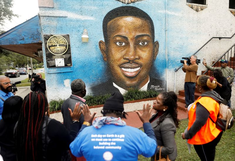&copy; Reuters. FILE PHOTO: People gather in front of a mural of Ahmaud Arbery painted on the side of The Brunswick African American Cultural Center demanding justice for Ahmaud Arbery in Brunswick, Georgia, November 4, 2021. REUTERS/Octavio Jones/File Photo