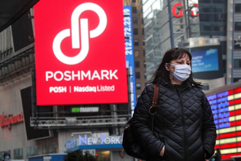 &copy; Reuters. FILE PHOTO: A woman walks through Times Square as a screen displays the company logo for Poshmark Inc. during it's IPO at the Nasdaq Market Site in Times Square in New York City, U.S., January 14, 2021.  REUTERS/Brendan McDermid