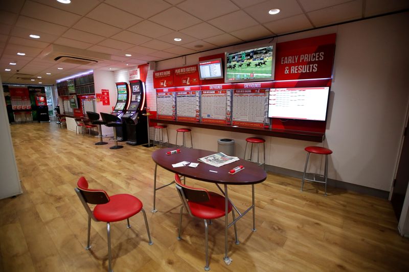 &copy; Reuters. FILE PHOTO: General view inside a deserted Ladbrokes shop in Harpenden as the spread of the coronavirus disease (COVID-19) continues, in Harpenden, Britain, March 18, 2020. REUTERS/Peter Cziborra/File Photo