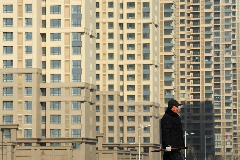 &copy; Reuters. FILE PHOTO: A resident walks past newly-built residential buildings under construction in Shenyang, Liaoning province February 18, 2012.  REUTERS/Sheng Li 