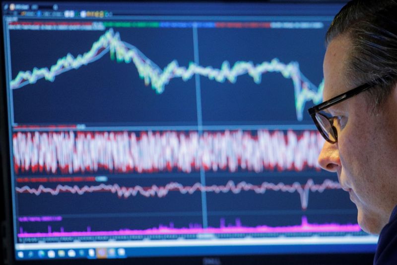 &copy; Reuters. FILE PHOTO: A trader works inside a booth on the floor of the New York Stock Exchange (NYSE) in New York City, U.S., November 8, 2021.  REUTERS/Brendan McDermid