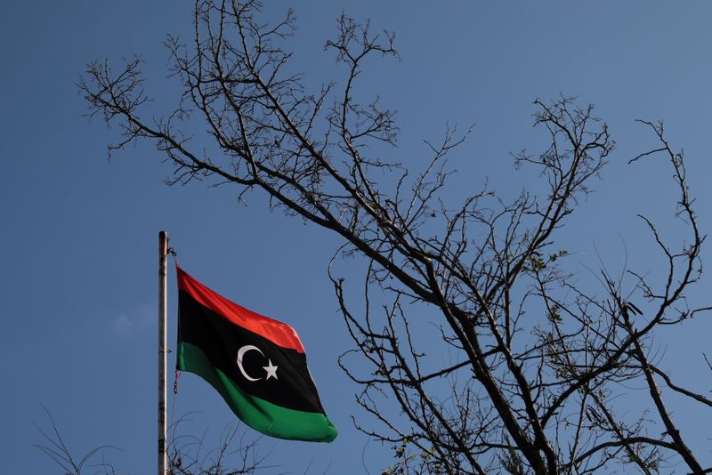 &copy; Reuters. FILE PHOTO: A Libyan flag flutters atop the Libyan Consulate in Athens, Greece, December 6, 2019. REUTERS/Costas Baltas