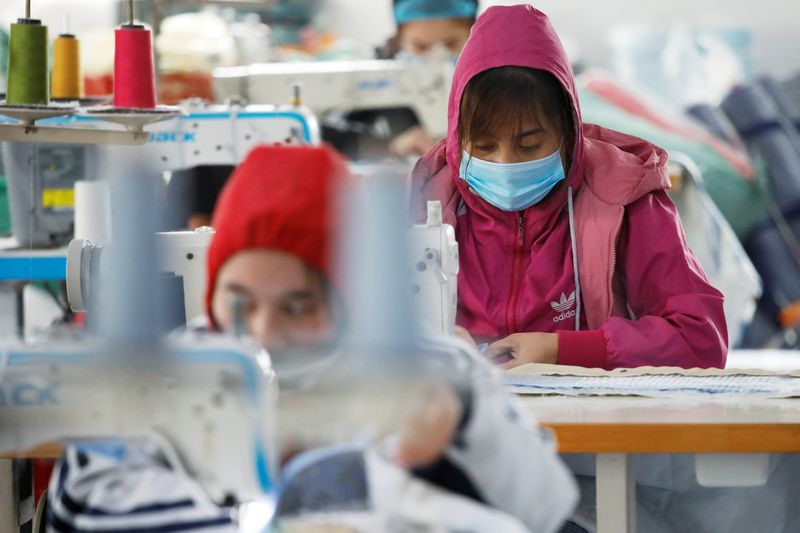 &copy; Reuters. FILE PHOTO: Labourers work at a private garment factory in Hanoi, Vietnam January 8, 2021. REUTERS/Kham