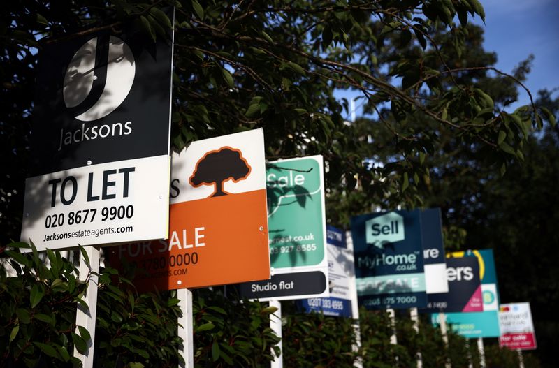&copy; Reuters. FILE PHOTO: Property estate agent sales and letting signs are seen attached to railings outside an apartment building in south London, Britain, September 23, 2021. REUTERS/Hannah McKay