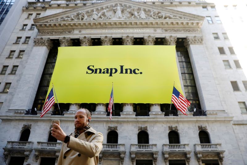 &copy; Reuters. FILE PHOTO: A man takes a photograph of the front of the New York Stock Exchange (NYSE) with a Snap Inc. logo hung on the front of it shortly before the company's IPO in New York, U.S., March 2, 2017.  REUTERS/Lucas Jackson