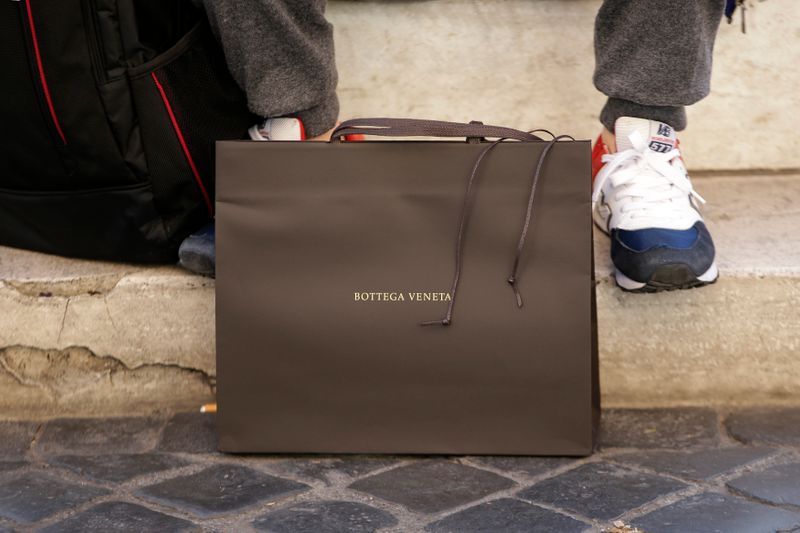 &copy; Reuters. FILE PHOTO: A man sits next a Bottega Veneta bag in downtown Rome, Italy March 1, 2016. REUTERS/Max Rossi