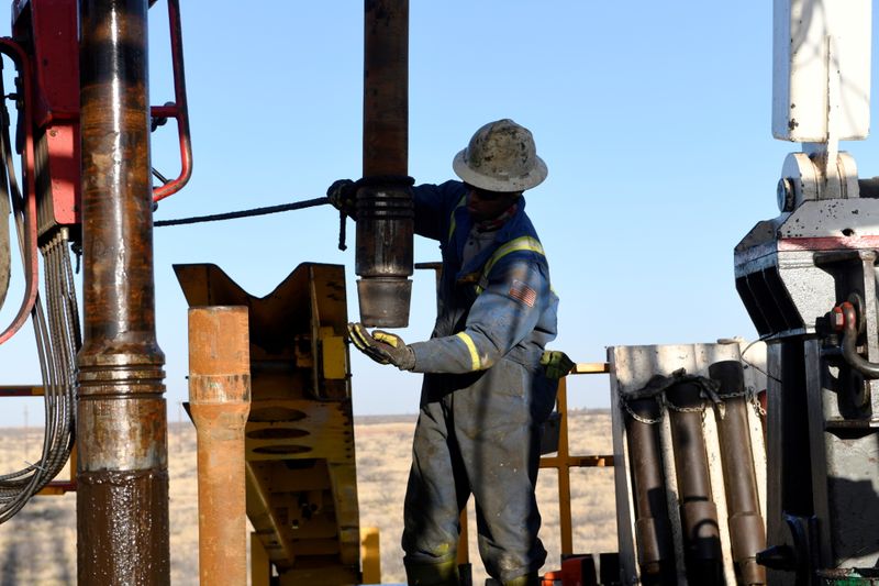 &copy; Reuters. FILE PHOTO: An oil worker removes a thread cap from a piece of drill pipe on a drilling lease owned by Elevation Resources near Midland, Texas, U.S., February 12, 2019. REUTERS/Nick Oxford/File Photo