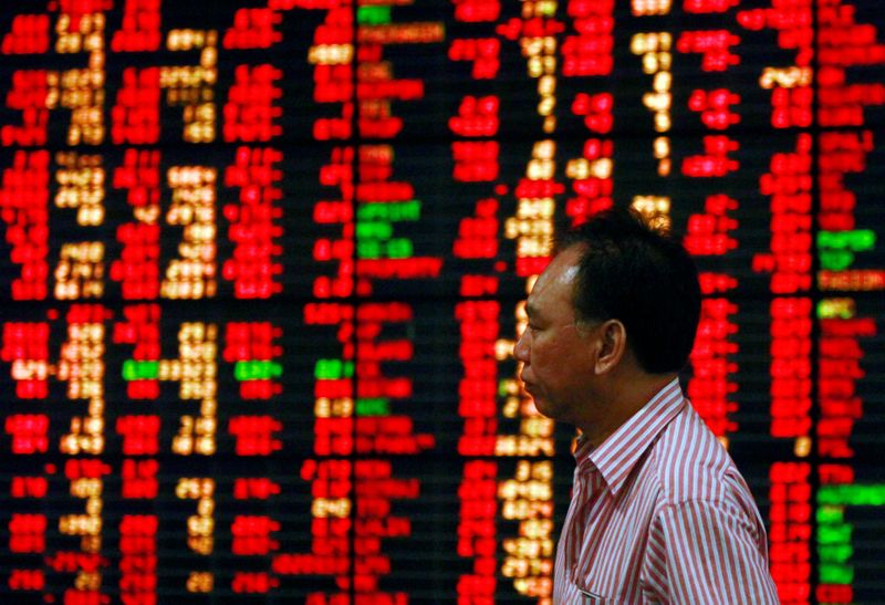 &copy; Reuters. FILE PHOTO: A Thai investor walks past an electronic board displaying live market data at a stock broker's office in central Bangkok August 9, 2011. REUTERS/Chaiwat Subprasom 