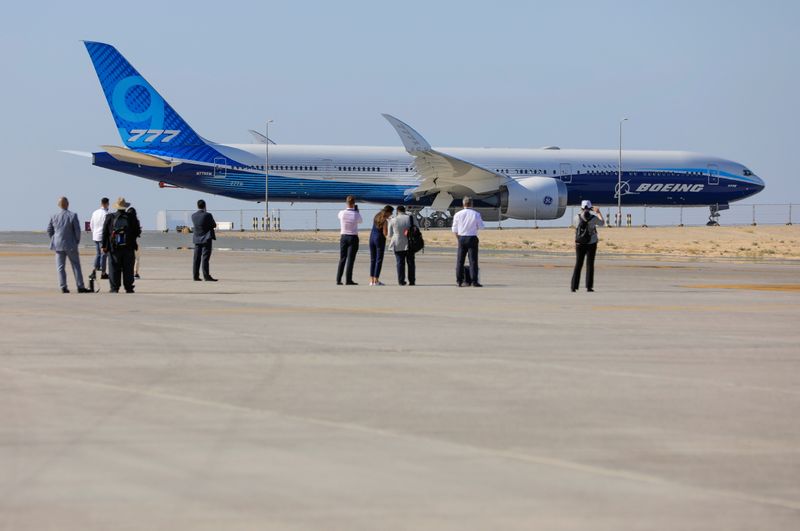 &copy; Reuters. FILE PHOTO: Visitors stand in front of the plane Boeing 777X during the Dubai Airshow, in Dubai, United Arab Emirates, November 14, 2021. REUTERS/Rula Rouhana/File Photo