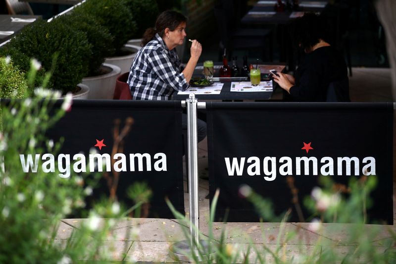 &copy; Reuters. FILE PHOTO: People sit in a Wagamama restaurant in London, Britain, October 5, 2020. REUTERS/Hannah McKay/File Photo