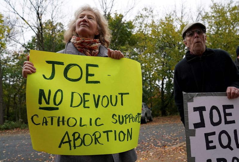 &copy; Reuters. FILE PHOTO: A protester holds an anti-abortion sign as U.S. Democratic presidential candidate Joe Biden attends church in Wilmington, Delaware, U.S., November 1,  2020. REUTERS/Kevin Lamarque/File Photo/File Photo