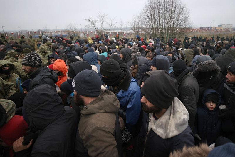 &copy; Reuters. Migrants queue to receive humanitarian aid near Bruzgi - Kuznica checkpoint on the Belarusian-Polish border in the Grodno region, Belarus November 16, 2021. Leonid Scheglov/BelTA/Handout via REUTERS  ATTENTION EDITORS - THIS IMAGE HAS BEEN SUPPLIED BY A T